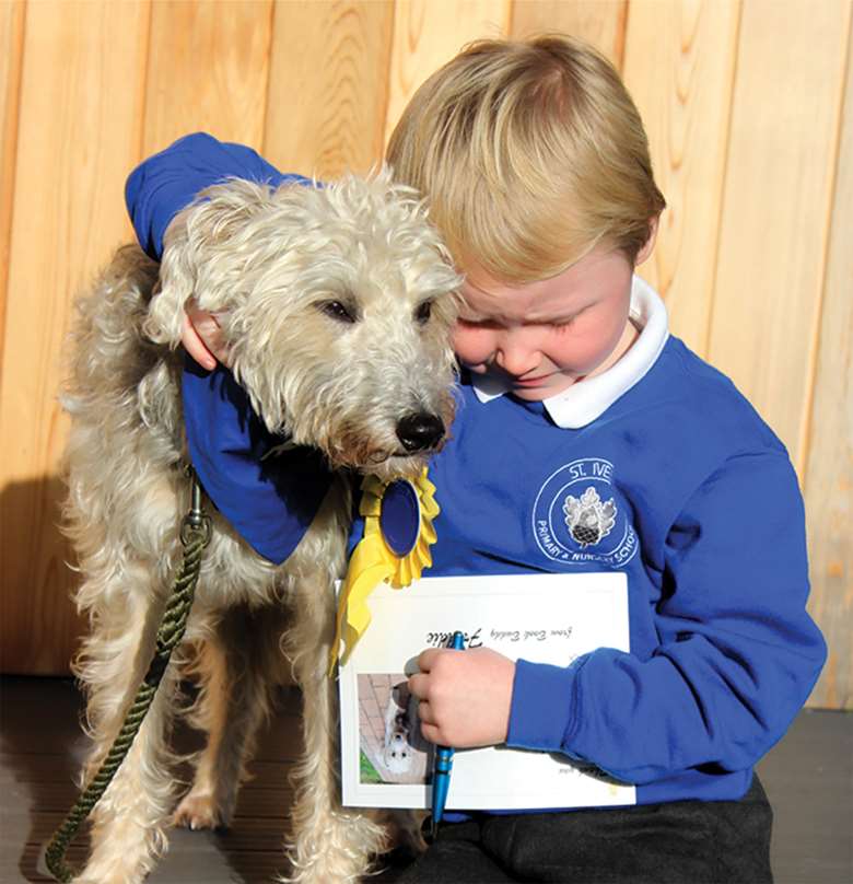 Children read to canine “book buddies” every week in term time, which develops pupils’ learning and listening skills