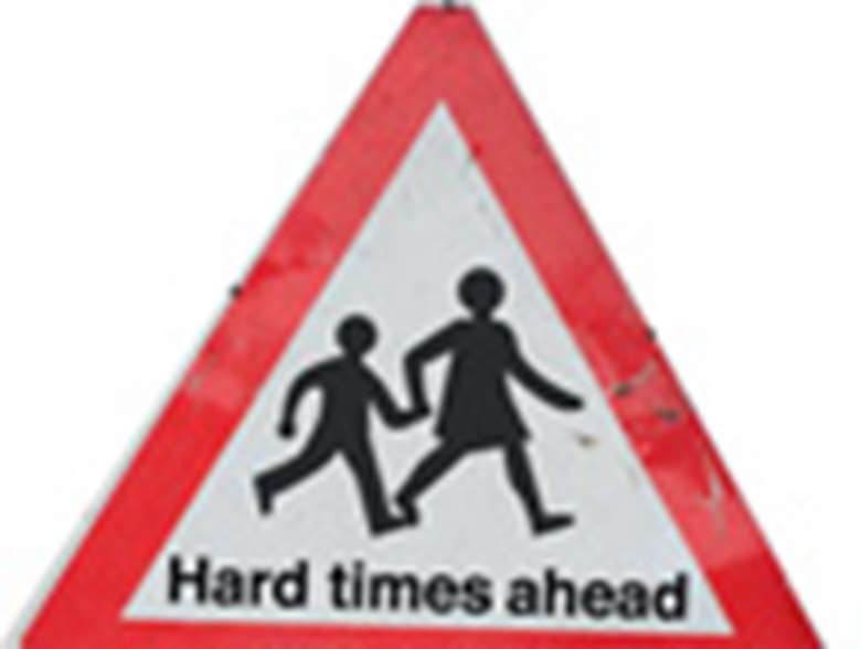 Road sign saying hard times ahead