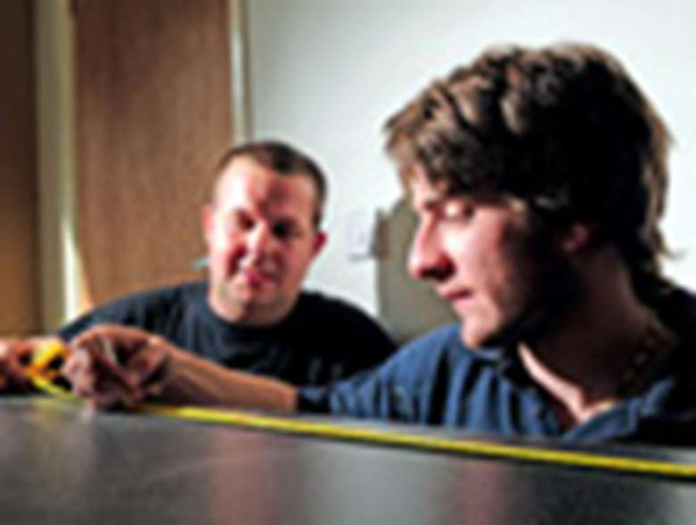 Allan Lamb (right) working as a joinery apprentice. Credit: Nigel Hillier