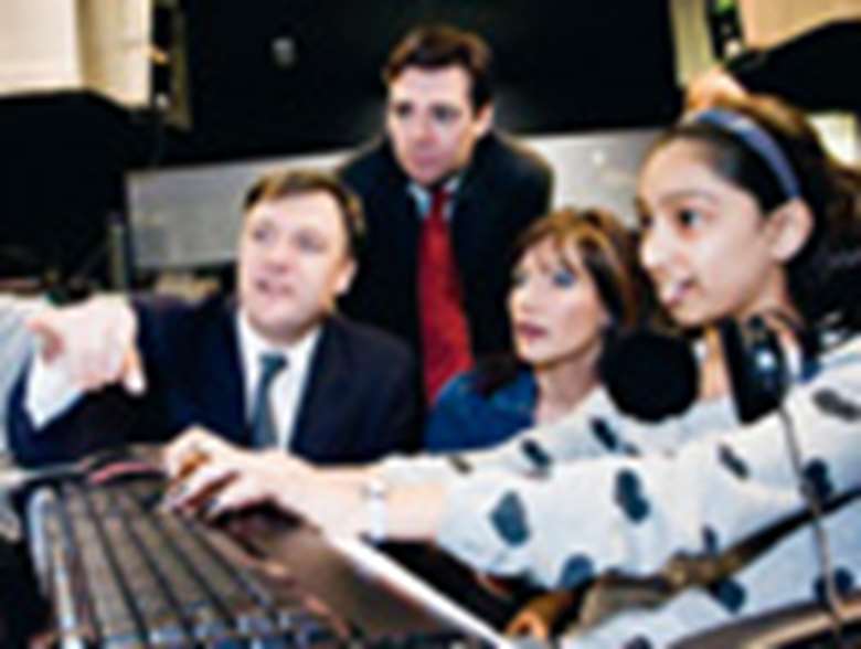 Ed Balls and young person using a computer. Credit: DCSF