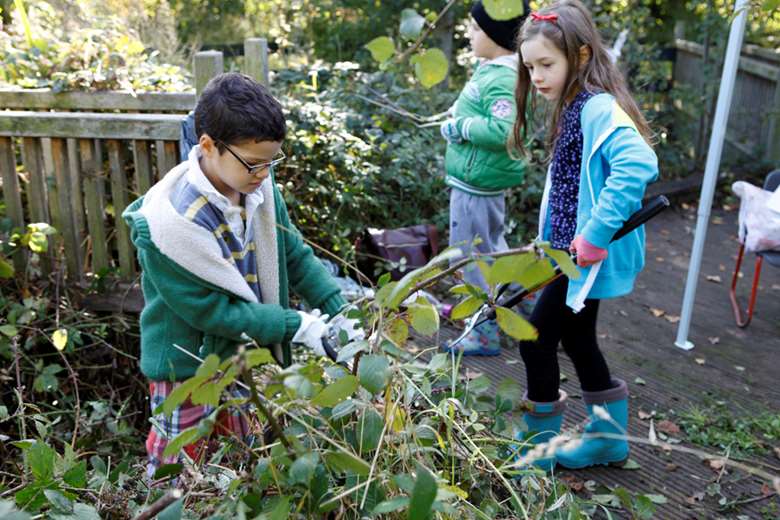 Children at a pop-up play shop in Lewisham regenerated an overgrown garden behind a disused school. Image: London Play