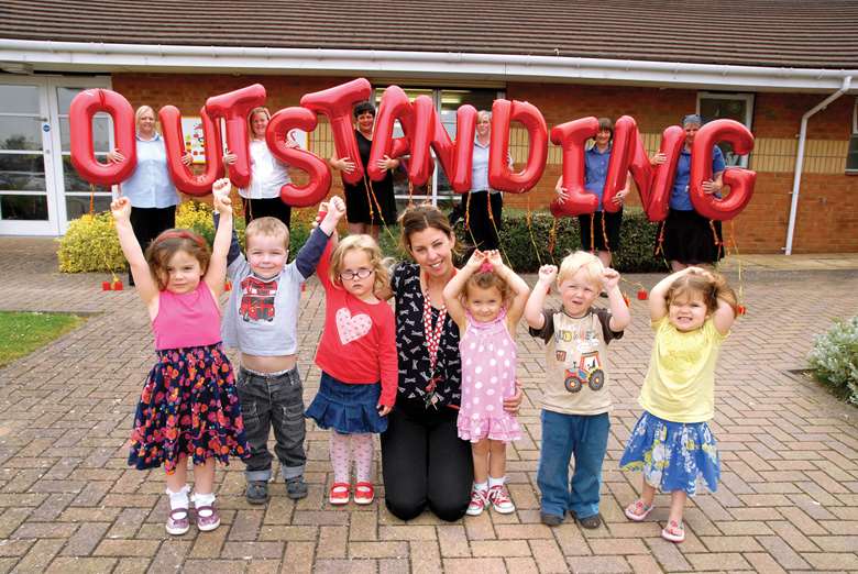Children and staff at the Busy Bees nursery celebrate being upgraded to outstanding
