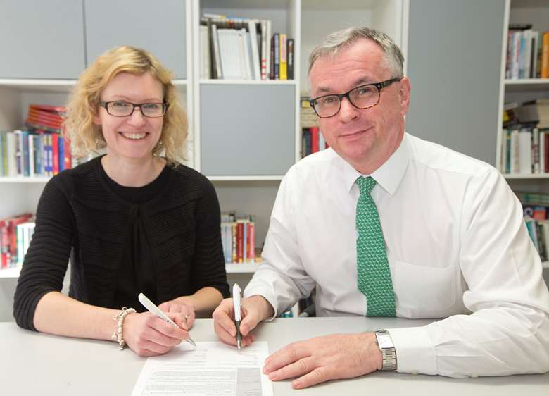 UK Youth chief executive Anna Smee signs the partnership agreement with Damian Leeson, a director at Lloyds Banking Group. Picture: Lloyds Banking Group