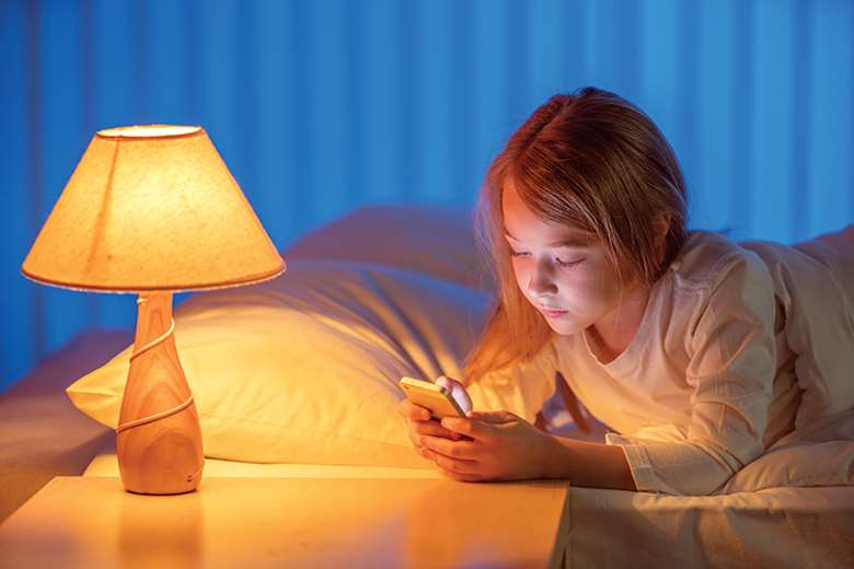 The Royal College of Paediatrics and Child Health recommends banning screens in the hour before bedtime. Picture: Realstock1/Adobe Stock