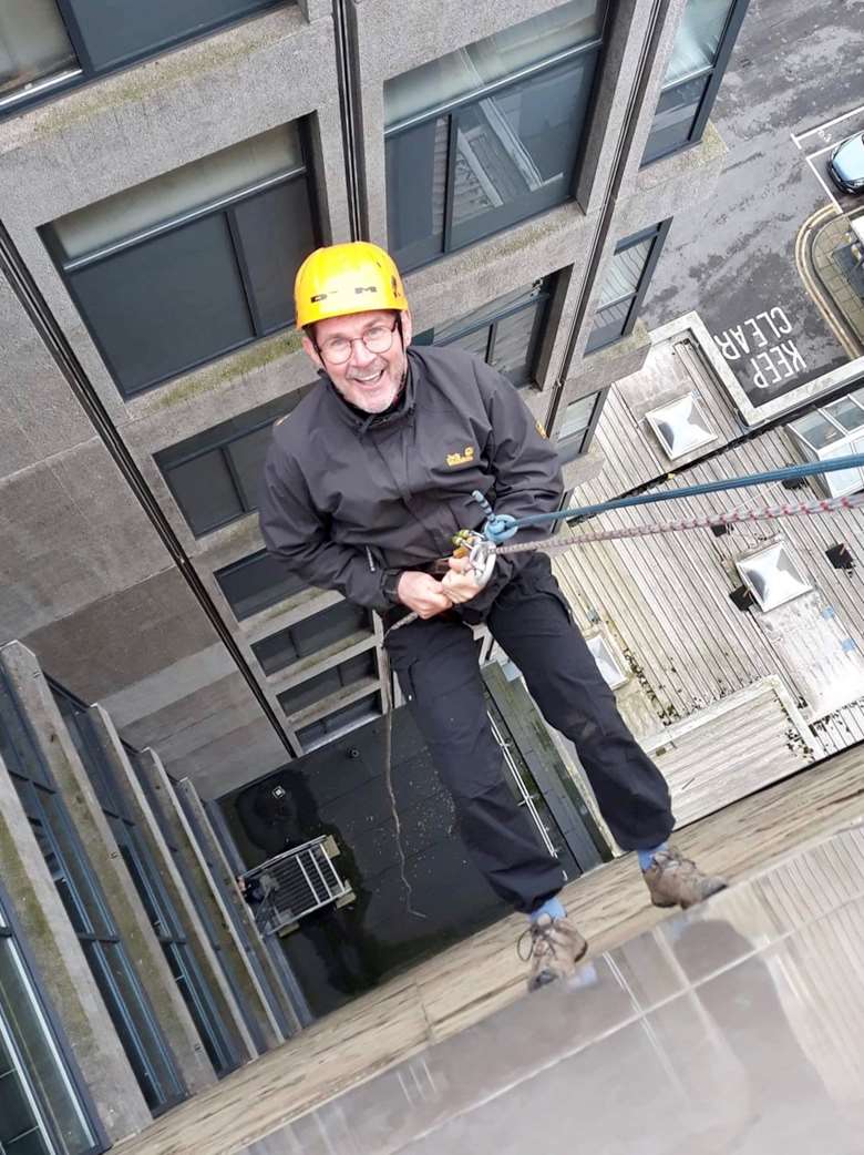 Leeds director of children and families Steve Walker abseils down the city's Portland Building. Picture: Leeds City Council 