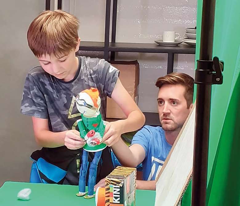 Children and parents think about their own "super powers" at a puppet workshop