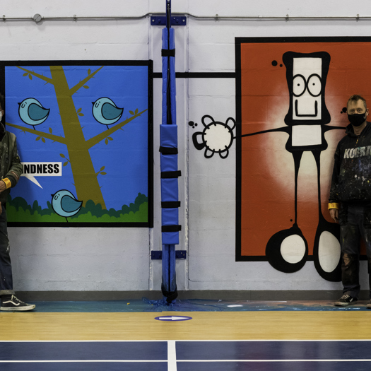 Artists Fark and My Dog Sighs with the mural in Portsmouth. Picture: Portsmouth City Council