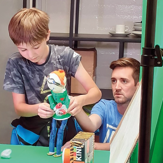Children and parents think about their own "super powers" at a puppet workshop